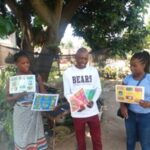 Distributing posters in Zimbabwe